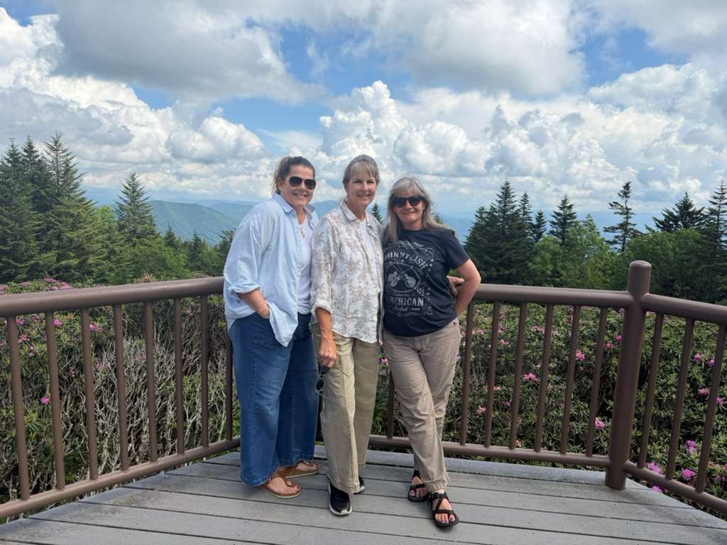 Sarah Bonsall of Latitude 21 Travel with her mother and sister on the observation deck at Roan Mountain State Park, the trip that proved travel insurance was worth it