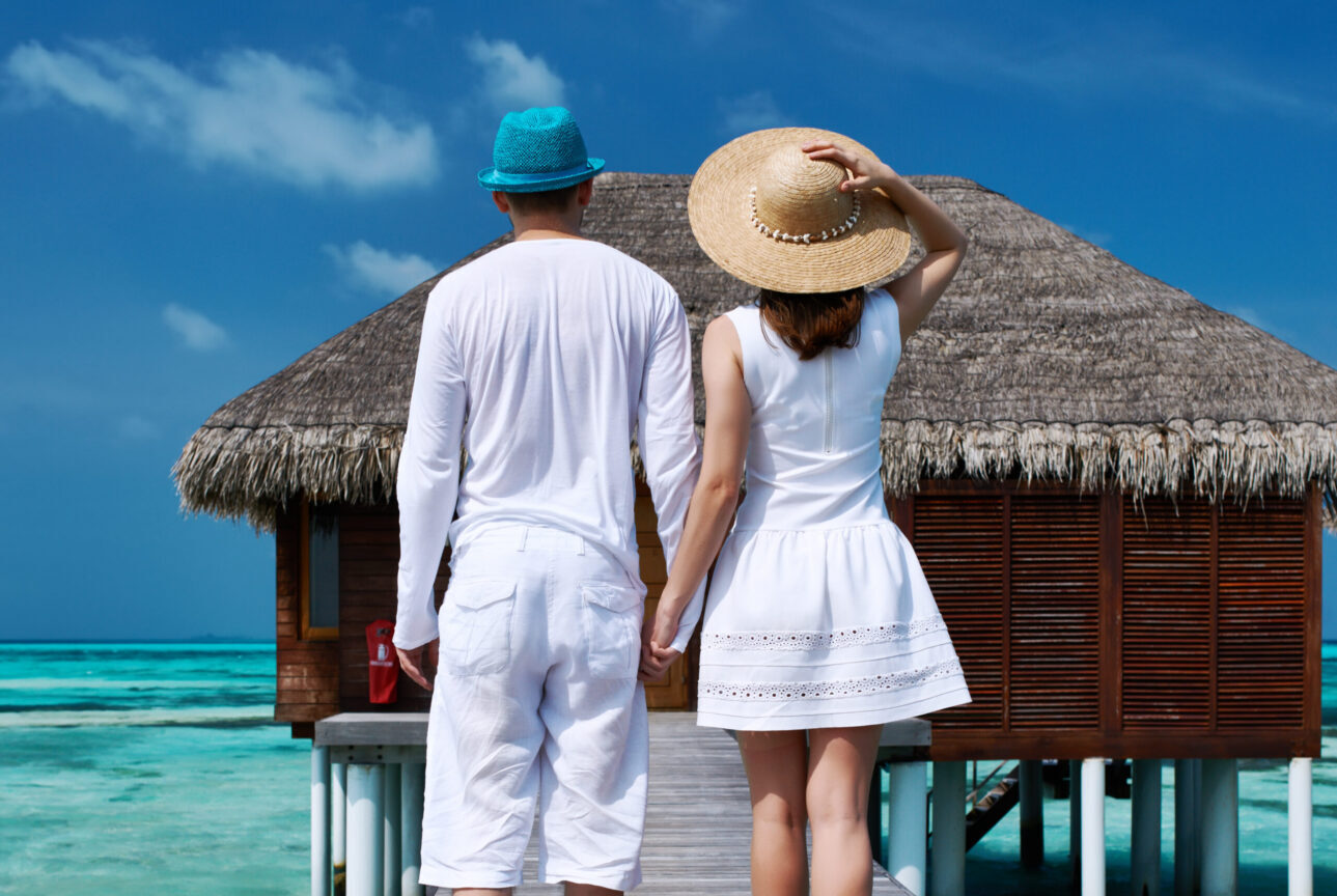 Overwater villa and turquoise lagoon at a Ritz-Carlton Maldives resort, a luxury honeymoon tour package in the Indian Ocean