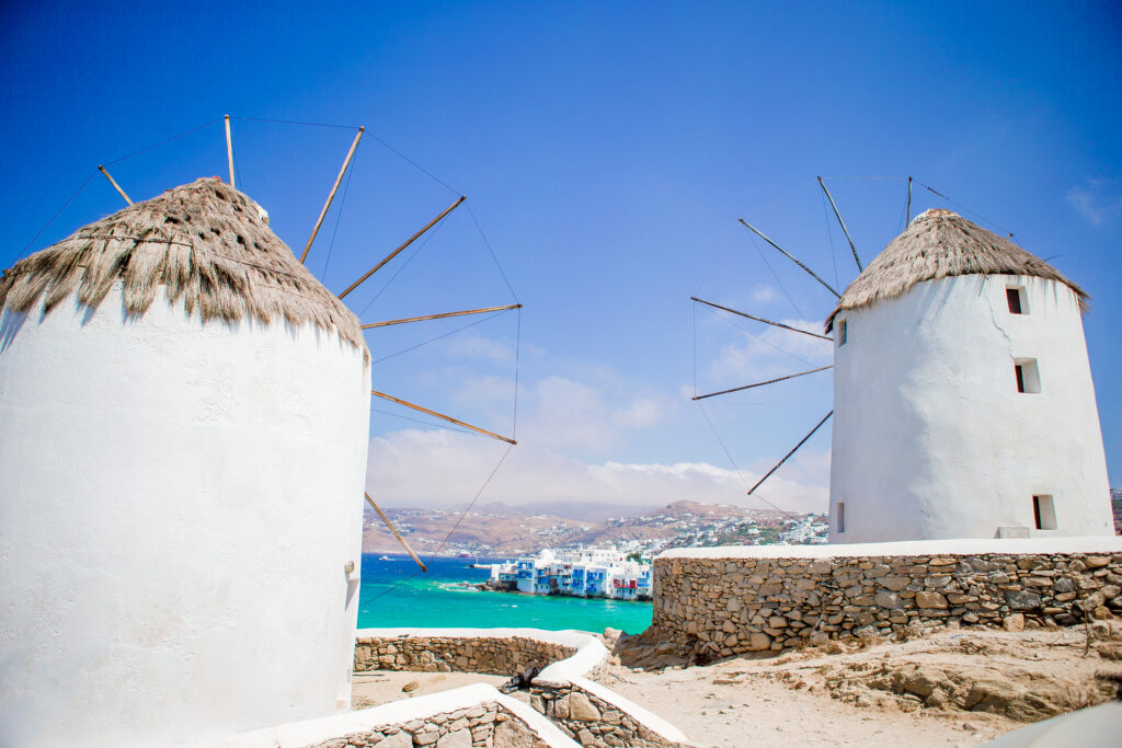 Iconic Kato Mili windmills in Mykonos Town, Greece overlooking Little Venice and the Aegean Sea