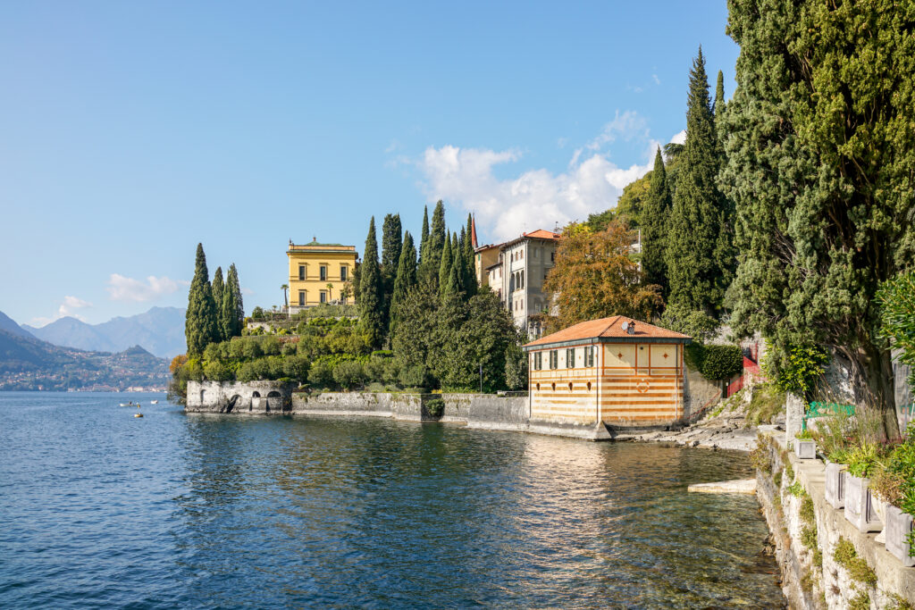 Lakeside villa surrounded by cypress trees at the edge of Lake Como