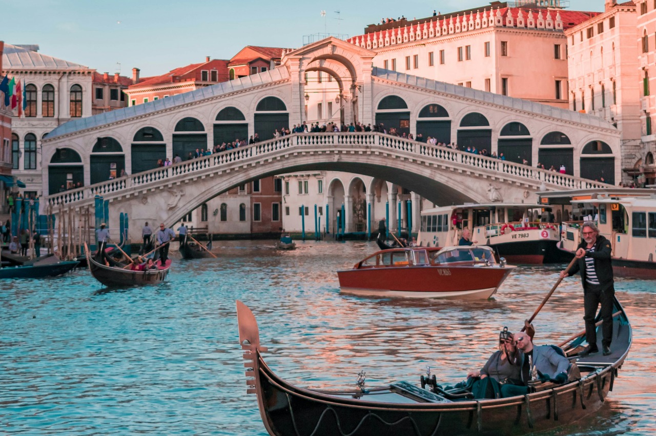 Gondola and water taxi on the Grand Canal by the Rialto Bridge, the Venice costs AI travel planning leaves out