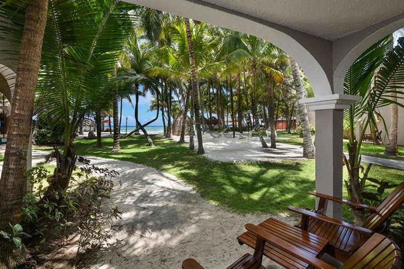 Room terrace framed by palms looking toward the sea at El Dorado Seaside Palms