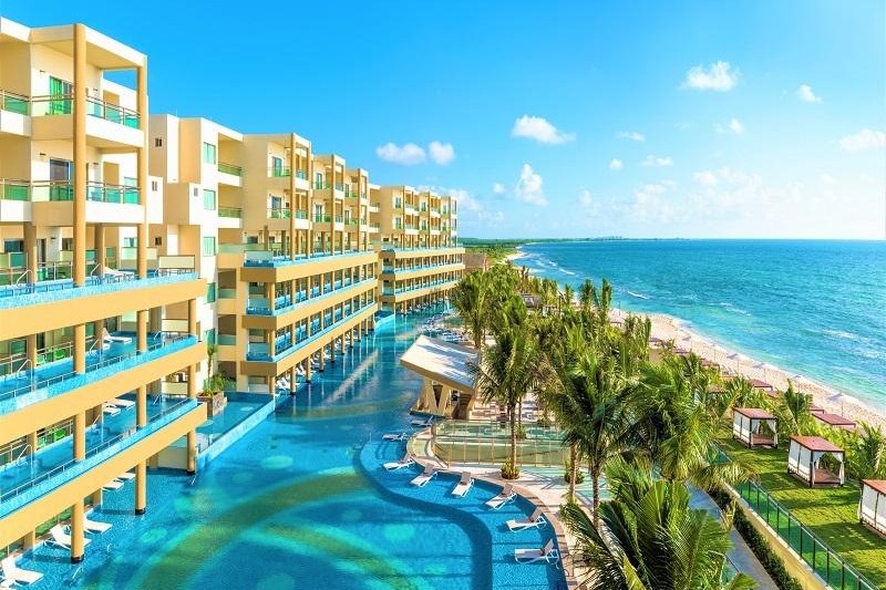 Beachfront building with multi-level pools at Generations Riviera Maya